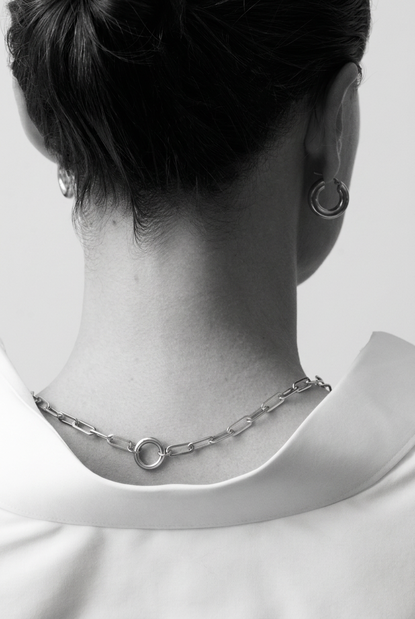 Fat Hoops Silver worn with a silver link chain, seen from behind in black and white