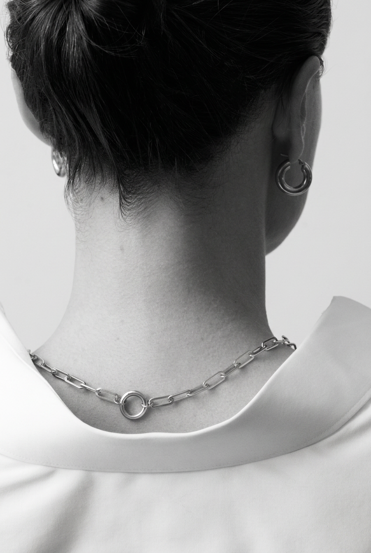 Fat Hoops Silver worn with a silver link chain, seen from behind in black and white