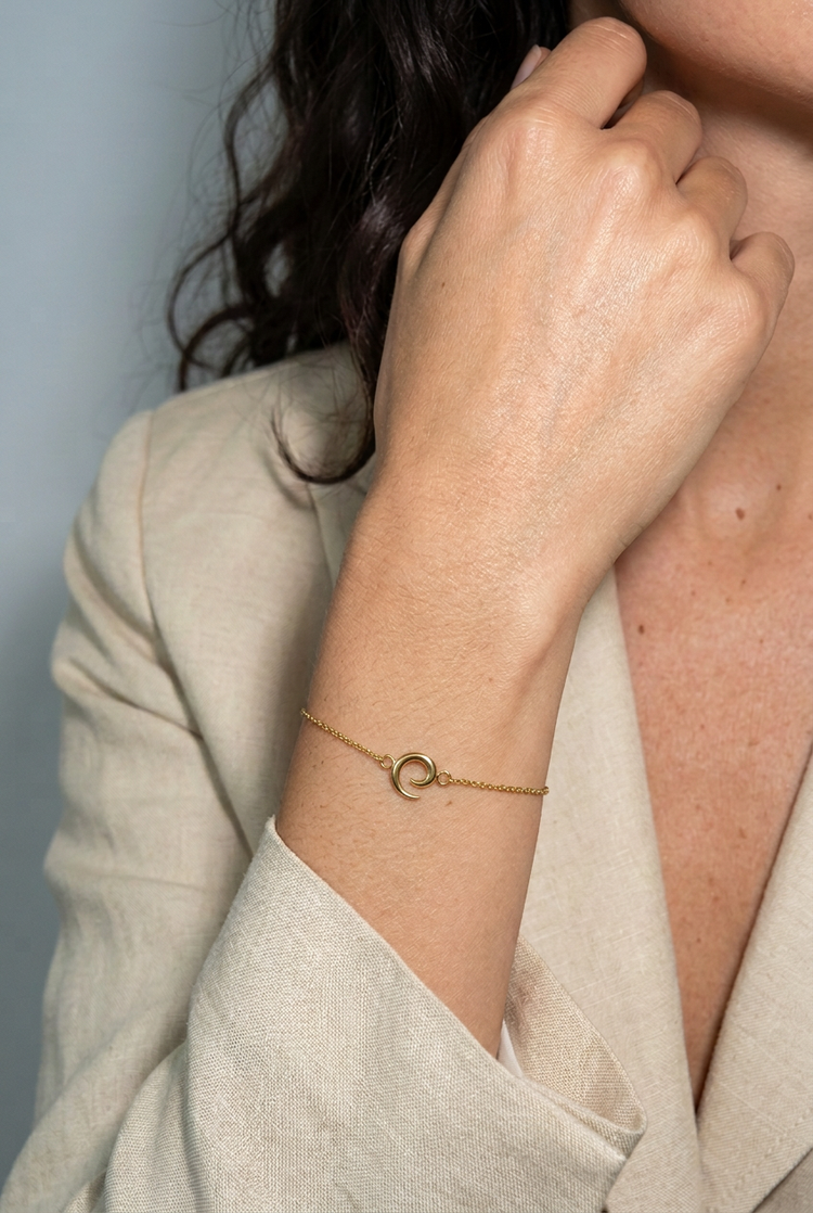 Mini Saturn Bracelet in gold worn on the wrist